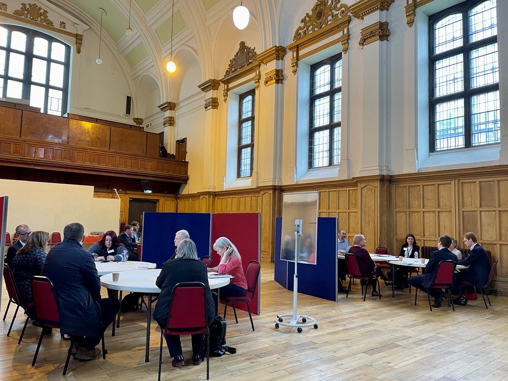 A photo showing Committee members and stakeholders discussing the National Performance Framework at the Committee's event in Glasgow on 10 May 2022.