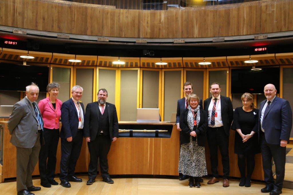 Photo of Members of the Senedd’s Finance Committee and the Scottish Parliament’s Finance and Public Administration Committee in the Senedd Chamber